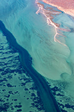 Load image into Gallery viewer, Aerial view of a river canal next to a desert landscape with clear blue and green water showing seagrasses in Shark Bay
